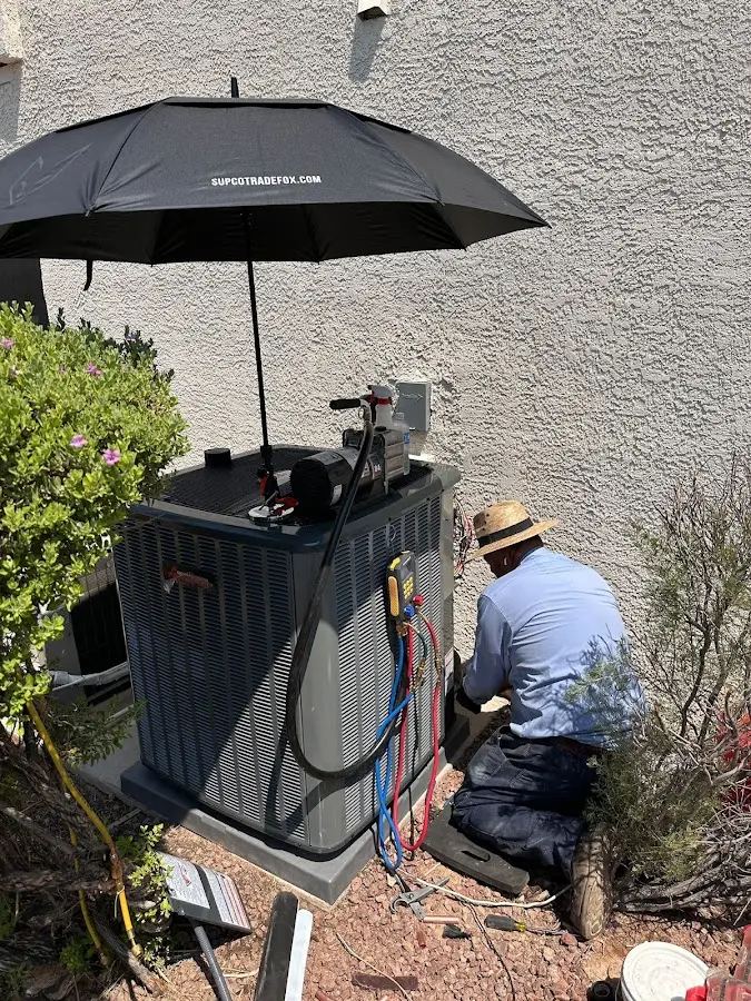 HVAC technician performing outdoor AC maintenance in Savoy